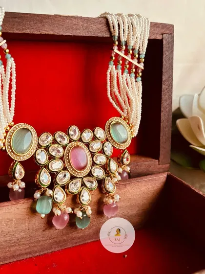 This pastel-coloured Kundan choker is a modern take on a traditional design. The soft pink and mint green stones make it a unique and fashionable choice for any event.