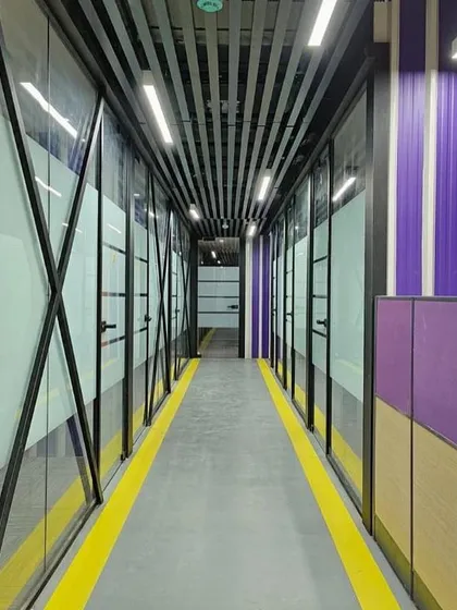 The corridor in the FedEx office uses bold colors and graphic lines to create a sense of energy and movement. The design reflects the dynamic nature of the logistics industry.