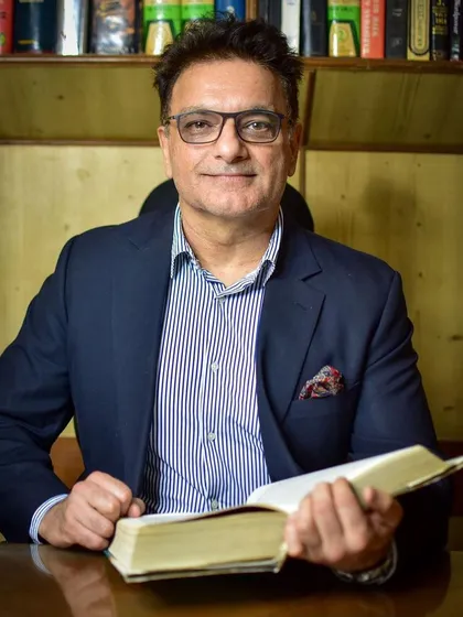 In my element, surrounded by the law books that form the bedrock of my practice. Every case is built on a deep understanding of legal precedent and statutes.