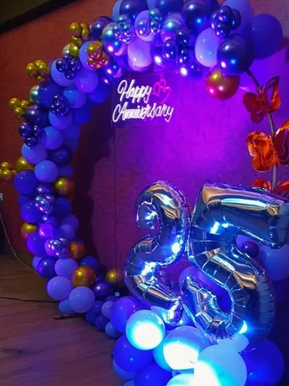 The 25th anniversary balloon circle with deep blue and purple lighting.