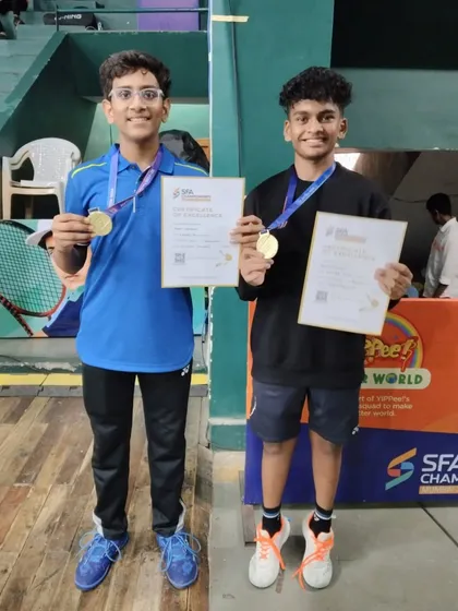 Aryan Pednekar and his partner with their gold medals and certificates after winning the U15 BD Title at the SFA Championship.