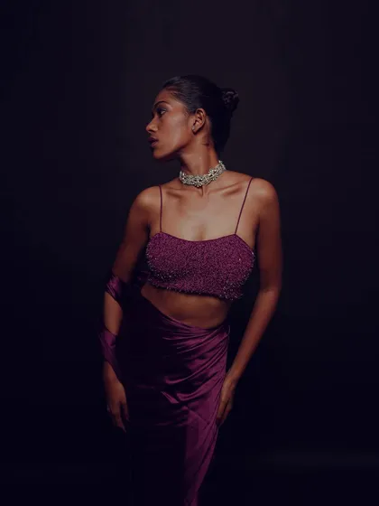 Another pose from the purple satin series, showcasing the modern and chic styling of the saree and the complementary makeup.