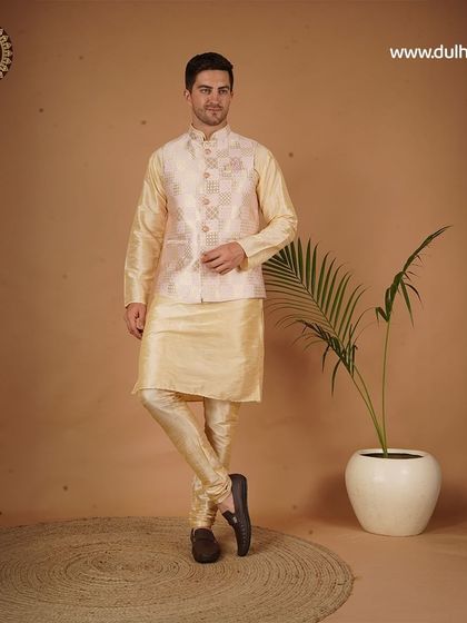 A classic cream-colored kurta set with a patterned Nehru jacket, perfect for an engagement ceremony.