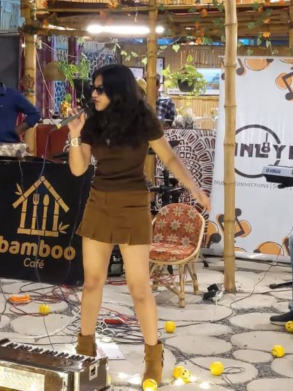 A full shot of me performing at the Bamboo Cafe. This image captures the unique, rustic vibe of the venue and the intimate nature of the acoustic performance.