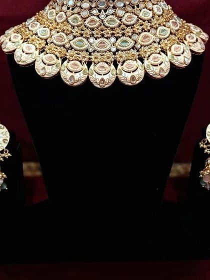 A beautiful meenakari choker with matching jhumkas. The enamel work is detailed and colorful, perfect for adding a pop of personality to your look.