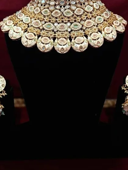 A beautiful meenakari choker with matching jhumkas. The enamel work is detailed and colorful, perfect for adding a pop of personality to your look.