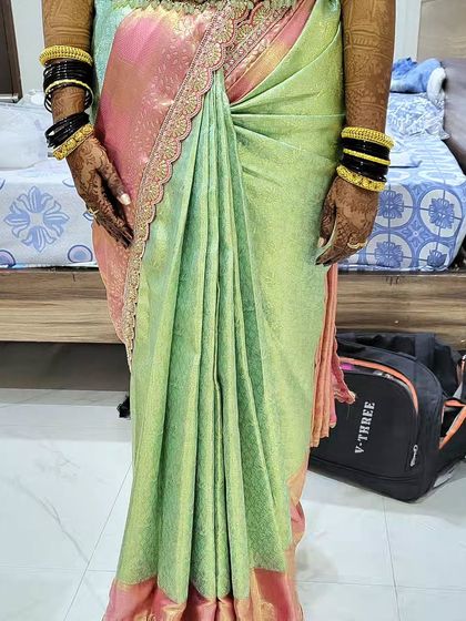 A close-up of the reception saree drape for Lavanya. You can see the neat hip pleats and the way the fabric is tucked to create a flattering, body-hugging fit that lasts all evening.