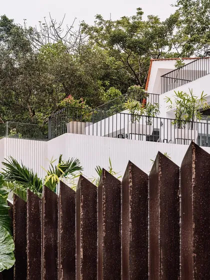 A view of the Tellado Villas' layered terraces, set against the property's custom metal boundary. The design showcases how we integrate safety and privacy features without compromising the connection to the natural, green surroundings.