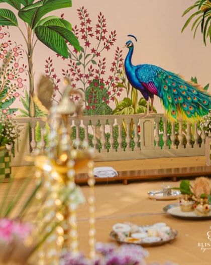 A closer look at the mandap stage, showing the hand-painted backdrop and the traditional balustrade. The attention to detail in the artwork made this a truly unique and memorable design.