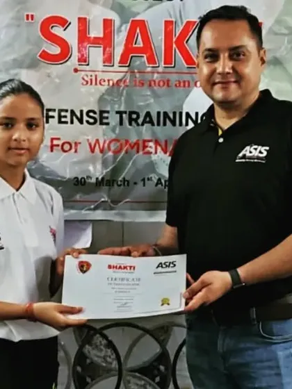 Another student being awarded her certificate after completing the three-day self-defense course.