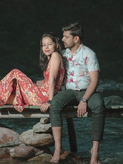 A beautifully composed shot of the couple by the river at night, creating a serene and intimate atmosphere for their pre-wedding photos.