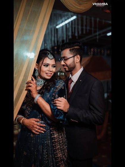 A romantic portrait of a couple at their reception. The soft lighting and their happy expressions create a warm and loving image.
