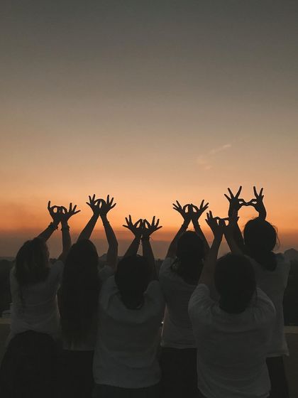 As the sun sets, students hold the lotus mudra towards the sky. This gesture symbolizes purity, beauty, and spiritual unfoldment, a perfect way to honor the end of the day.