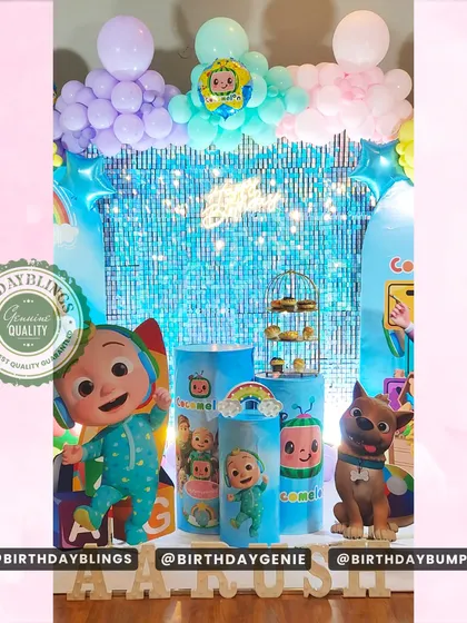 This Cocomelon setup includes a blue shimmer wall and multiple character cutouts, creating a bright and engaging photo area.