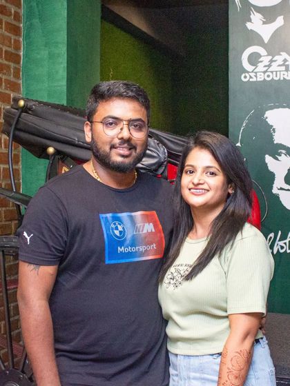 This couple is all smiles, posing in front of our unique wall art.