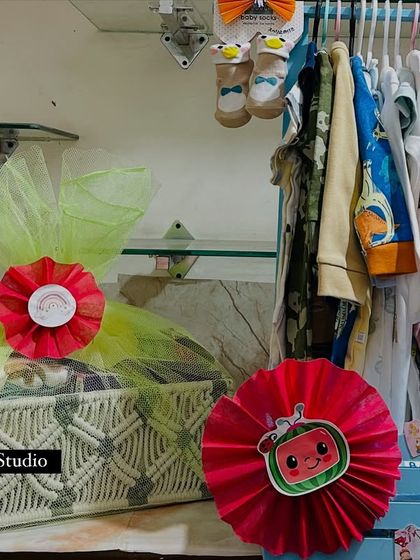A view of my workspace, showing a Cocomelon themed macrame basket next to the baby wardrobe hamper, ready for a newborn celebration.