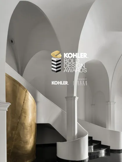 A third visual from the Kohler Awards, highlighting the interplay of the grand staircase and the sculptural brass element.