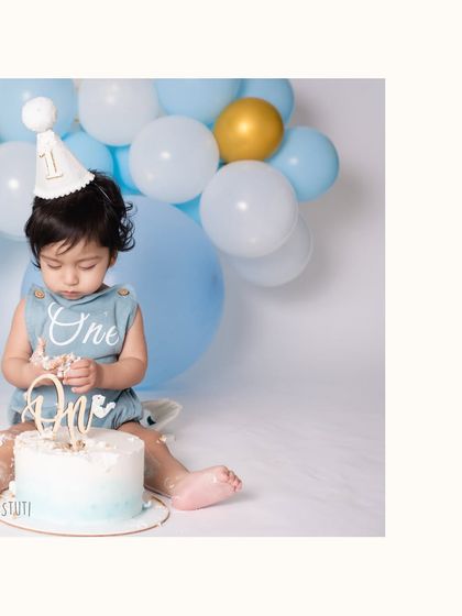 A close up of the cake smash action. The concentration on his face as he investigates the cake is just adorable. These are the little moments that tell the story of their first birthday.