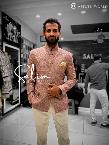 A client in a pink patterned Jodhpuri jacket paired with white trousers. This is a great color choice for daytime events and spring weddings.