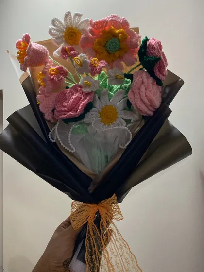 The same beautiful mixed bouquet of pinks, whites, and yellows, seen from a different angle to show its fullness.