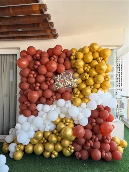 A modern and artistic balloon wall created for a birthday celebration. This style of organic balloon arrangement is perfect for creating a unique photo backdrop in any color scheme.