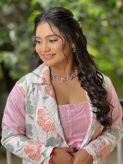 A playful and whimsical look for a carnival-themed event. The makeup has hints of glitter and the hair is styled in soft waves.