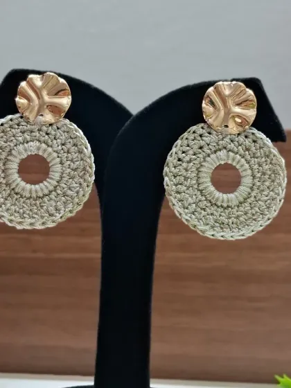 A pair of our elegant crochet earrings, featuring a beige circular design with a hammered gold-finish stud. These are lightweight and perfect for both everyday wear and special occasions.