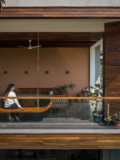 We believe in blurring the line between inside and outside. This balcony at Twin Villa, with its custom swing and warm wood palette, is designed not as an extra, but as an extension of the living space, a quiet place for pause, framed by the surrounding trees.