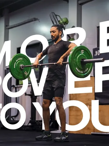More power to you. This image of an athlete performing an upright row with a barbell captures the spirit of our strength program, where every workout unlocks a stronger version of yourself.