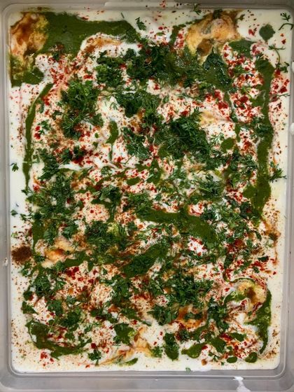 A large tray of my creamy and flavorful Dahi Vada, garnished with chutneys, spices, and fresh coriander.