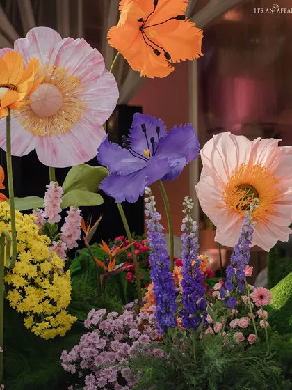 A detailed shot of the handcrafted flowers, showing the variety of shapes, colors, and materials used.