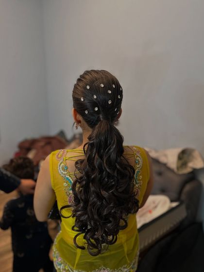 A view of the crystal-studded ponytail, showing the length and volume of the curls.