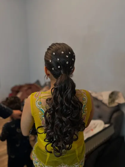 A full-length view of the volume ponytail with crystal accessories, perfect for a glamorous evening event.