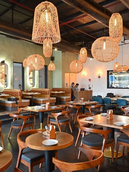 An alternate view of the dining space, showing the cohesive flow between different seating zones. The arrangement of tables and booths was carefully planned to maximize capacity without sacrificing guest comfort or the feeling of spaciousness.