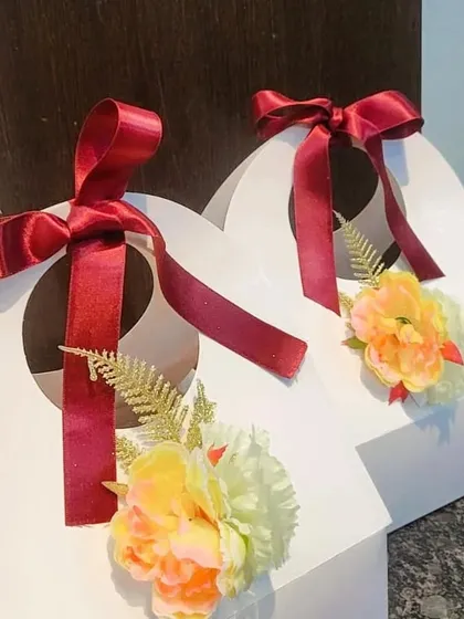 Another view of the Universal Happiness Hamper, showing the elegant ribbon and floral decoration.