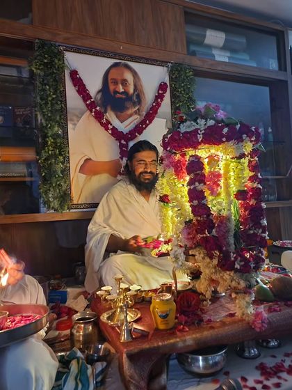 The priest performing the rituals during the Rudra Puja. The beautiful flower decorations and offerings created a truly sacred atmosphere.