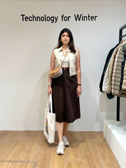 The same comfortable and stylish outfit, perfect for the fall season in Delhi. The neutral tones of the vest and skirt make it easy to wear and accessorize.