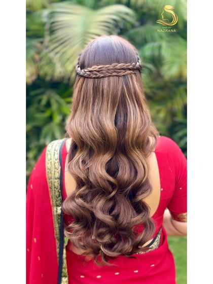 A back view of the waves and braids hairstyle, showing the beautiful texture of the hair.