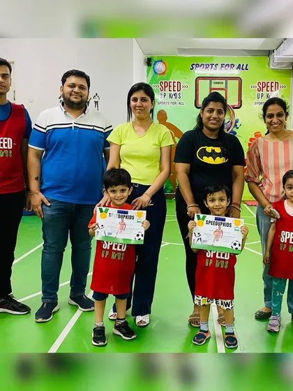 The 'Most Valuable Kid of the Month' award goes to Parth. Here he is with his family and coaches, celebrating his achievement.