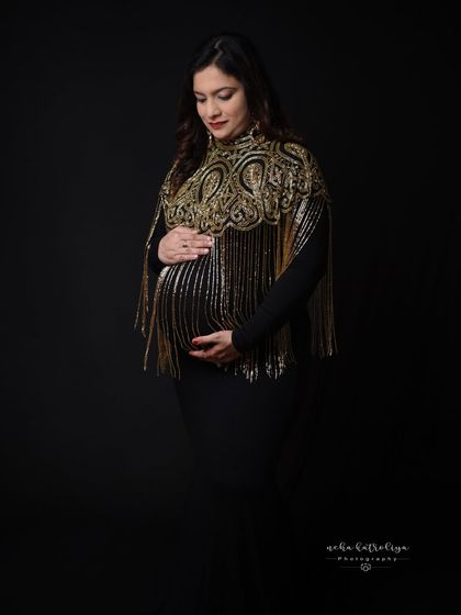 This black gown with a stunning gold fringed capelet is the definition of glamour. It's a unique piece from my client wardrobe for a truly standout portrait.