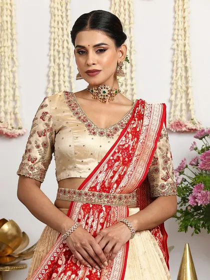 A close-up of the blouse and the draped dupatta, highlighting the intricate embroidery and the rich weave of the Banarasi silk.