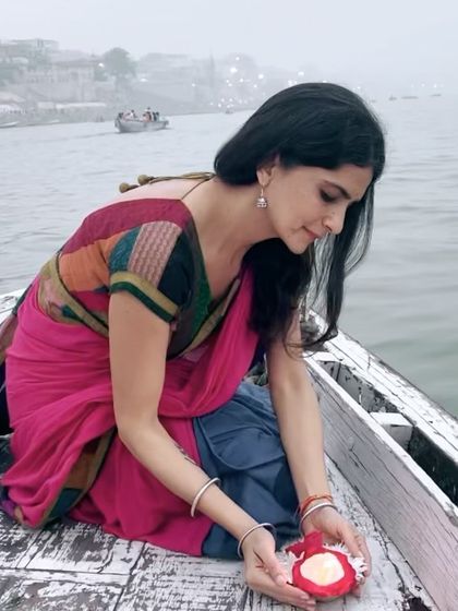 A photo version of the same moment, holding a candle, a symbol of light and hope.