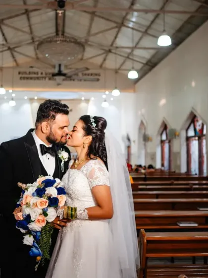 A 'just married' kiss inside the quiet church. After the ceremony, we take a few moments to capture the first few minutes of being husband and wife in a peaceful, intimate setting.