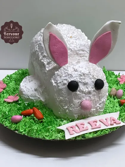 A 3D rabbit cake perfect for an animal lover's birthday. This chocolate truffle cake is shaped like a bunny and covered in textured whipped cream, with only the ears made of fondant.