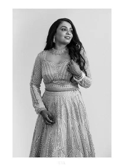 A classic and elegant black and white portrait of the bride in her beautiful reception outfit.