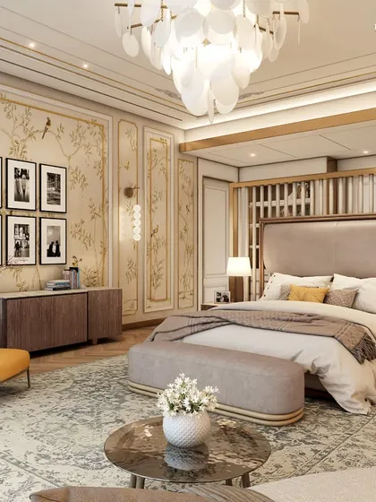 This Parisian-style primary suite is a haven of elegance and comfort. It features hand-painted wallpaper, intricate ceiling mouldings, and a stunning chandelier, complemented by brass and gold accents that sparkle with understated luxury.