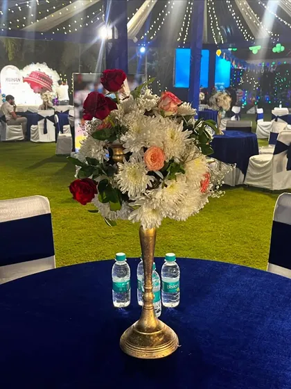 A close-up of a table centerpiece within the blue and white themed event.