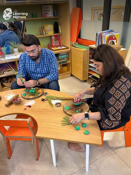 Parents at our orientation session engage in a playdough exploration with natural materials. These hands-on experiences help them understand how we use open-ended play to nurture creativity and fine motor skills in their children.