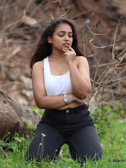 A thoughtful, pensive pose in the same casual outfit.