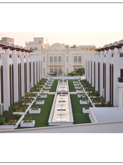 A view down the central landscaped deck of the Muscat townhouse project. The repetition of form and the linear water feature create a sense of order and tranquility within the community.